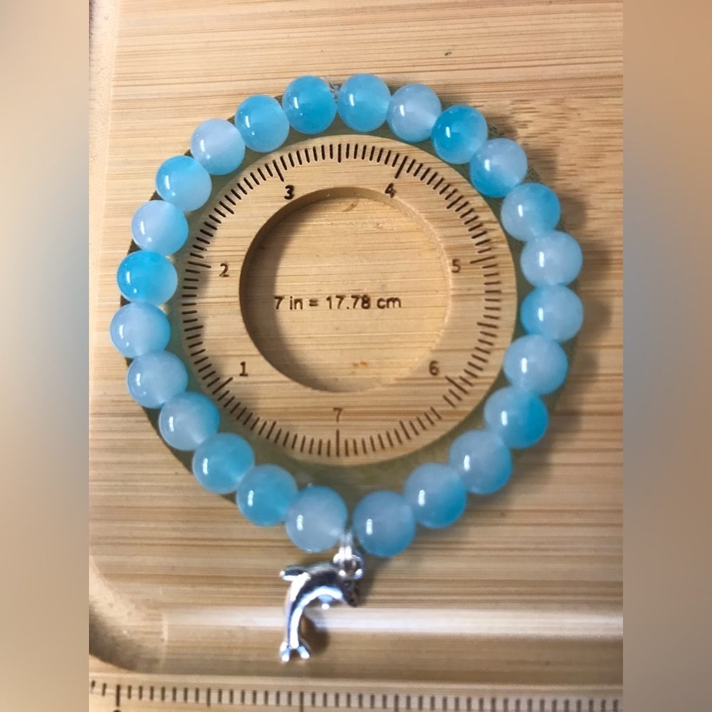 Solve dolphin with blue and white glass beads